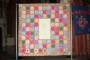 The quilt made by Christine Anderson honoring the victims of the OLA fire. Every victims is represented by a square on the quilt.